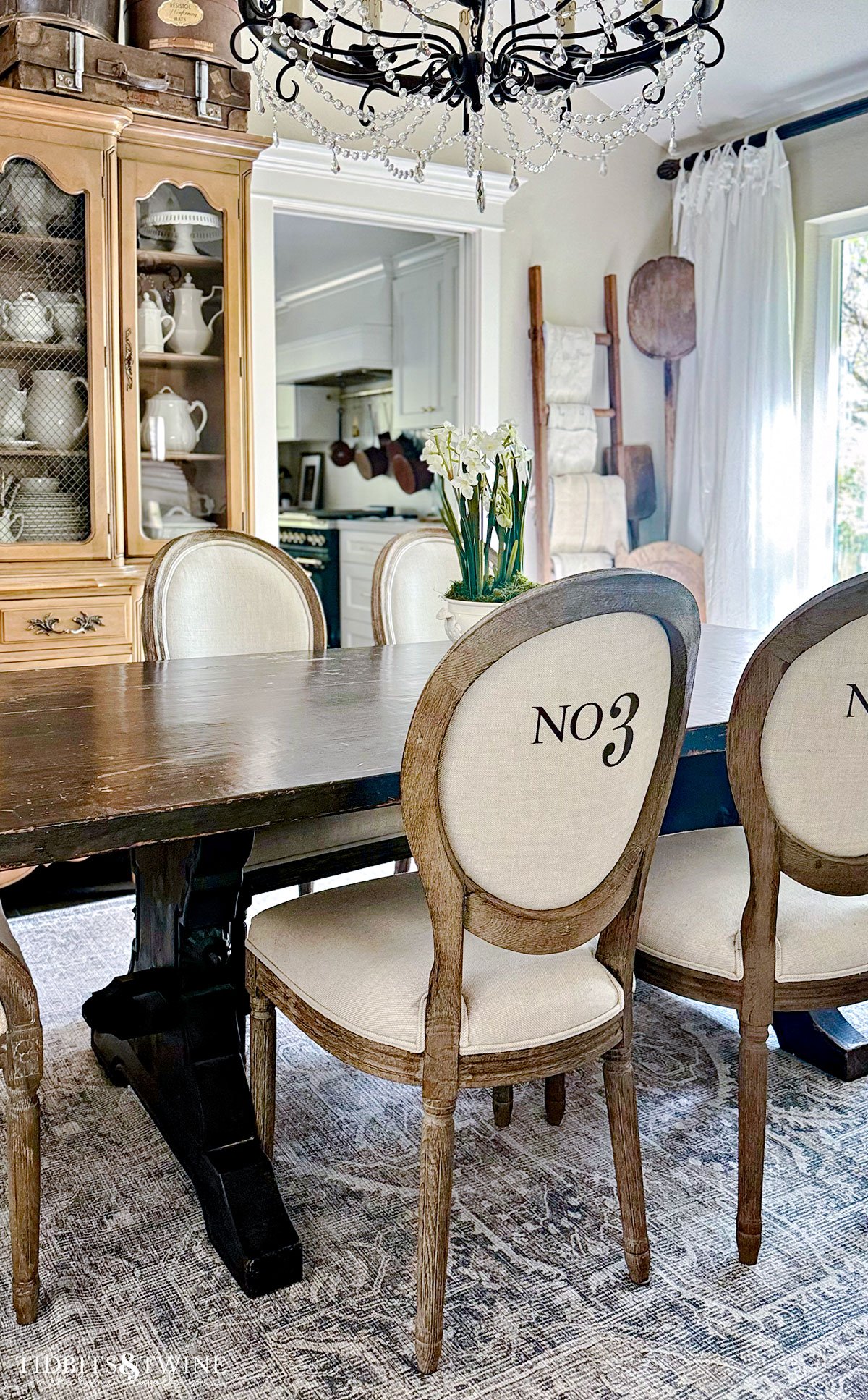 french style dining table with linen numbered dining chairs and trestle table
