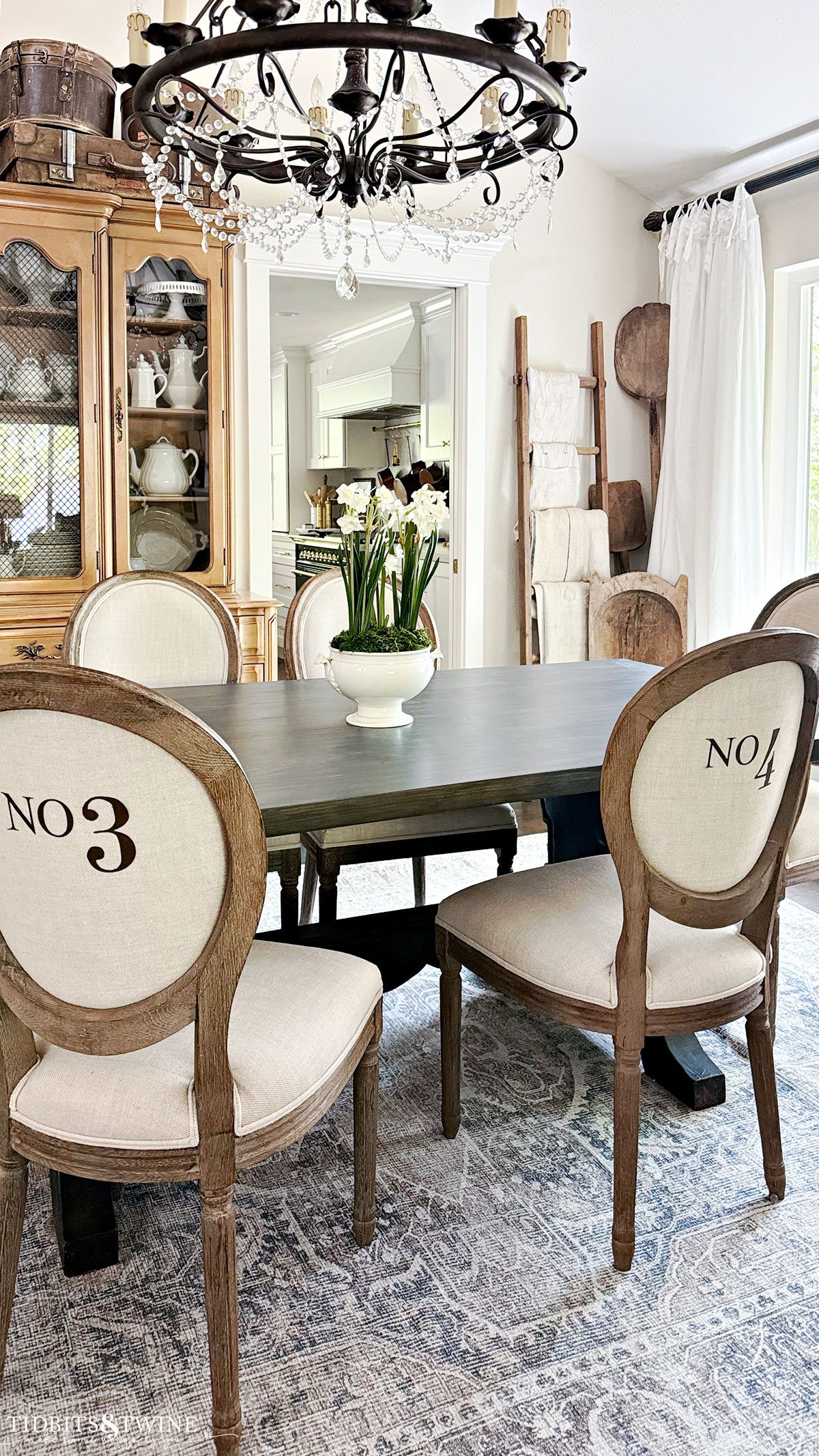 dining room with european antiques and numbered dining chairs