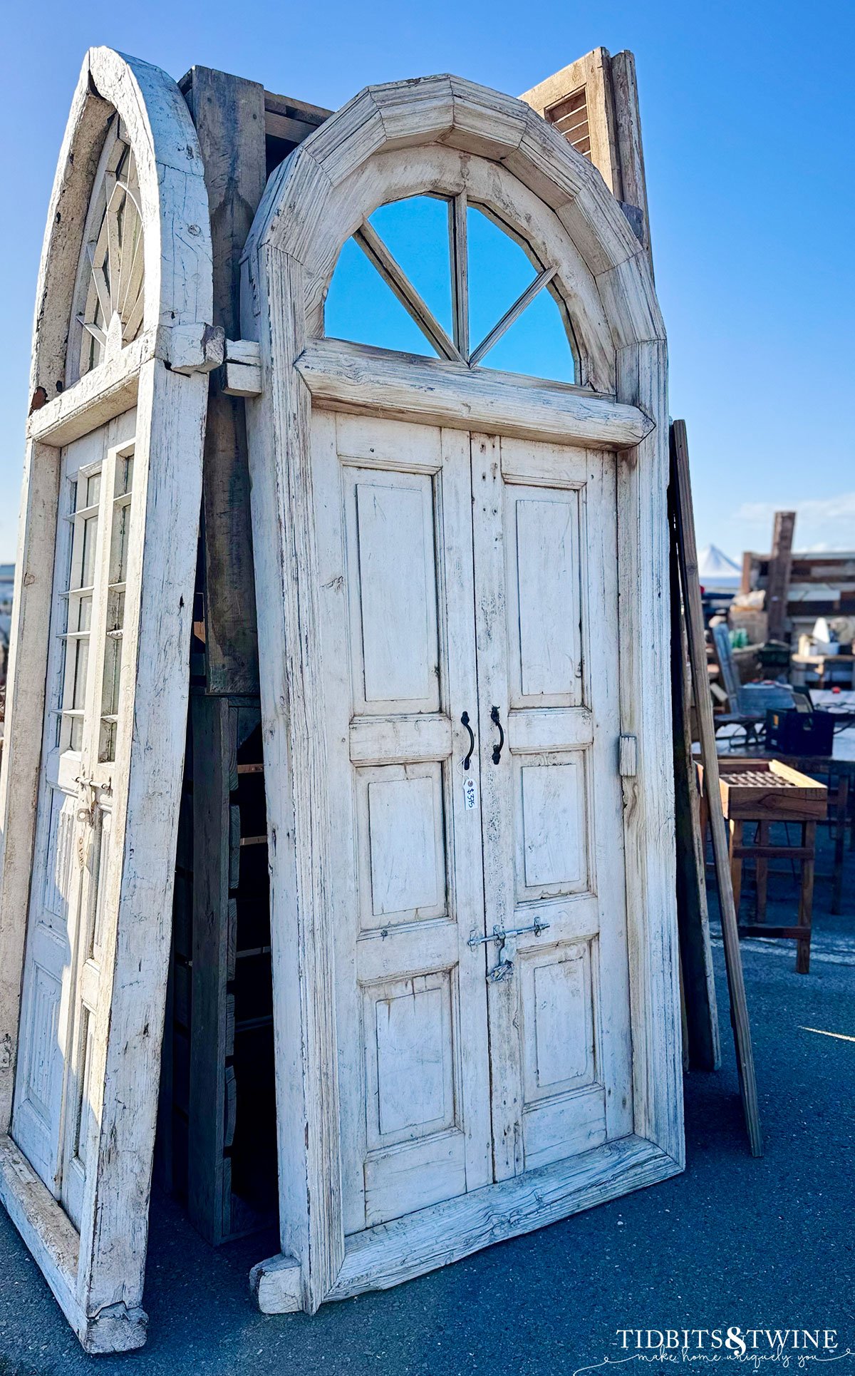 antique salvaged double doors with arched window at the top