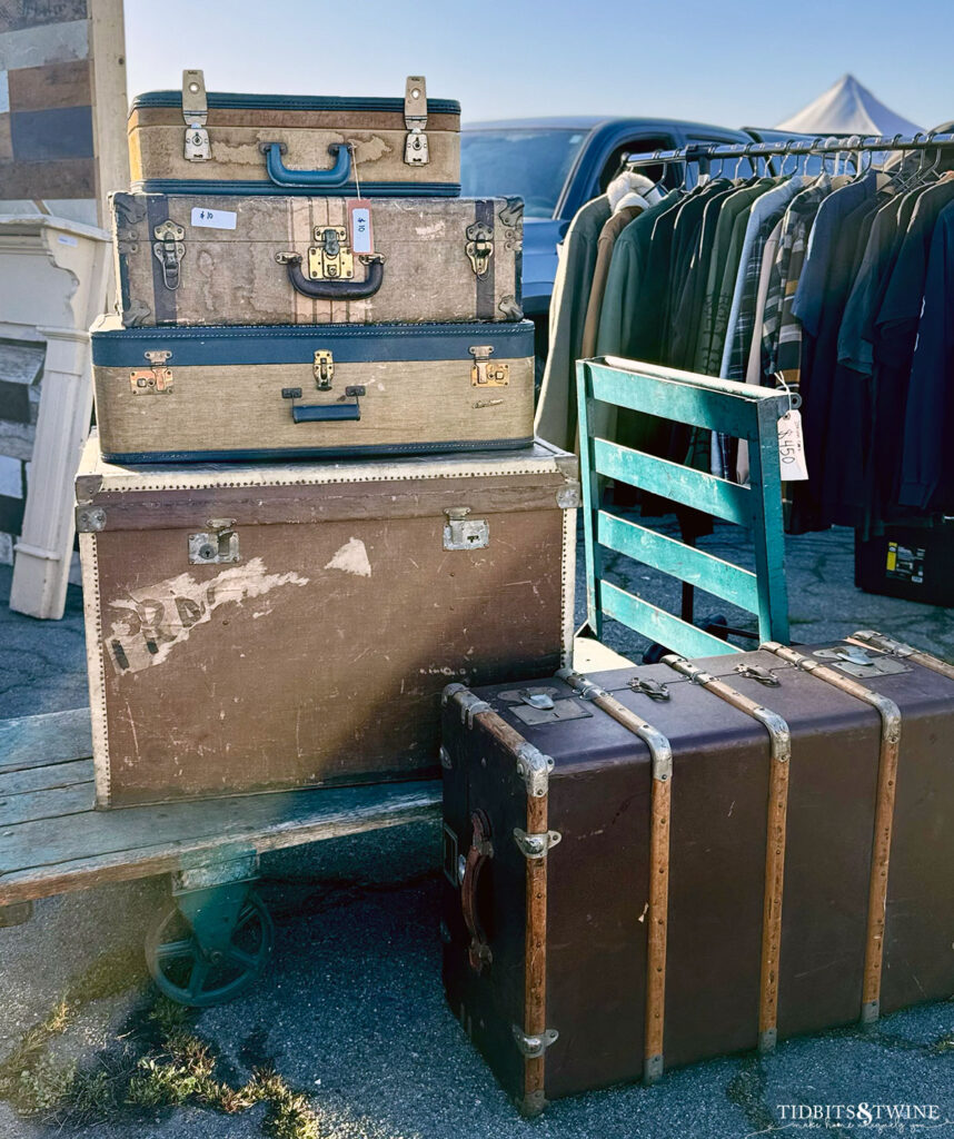 vintage luggage rack with antique suitcases and trunks stacked on top