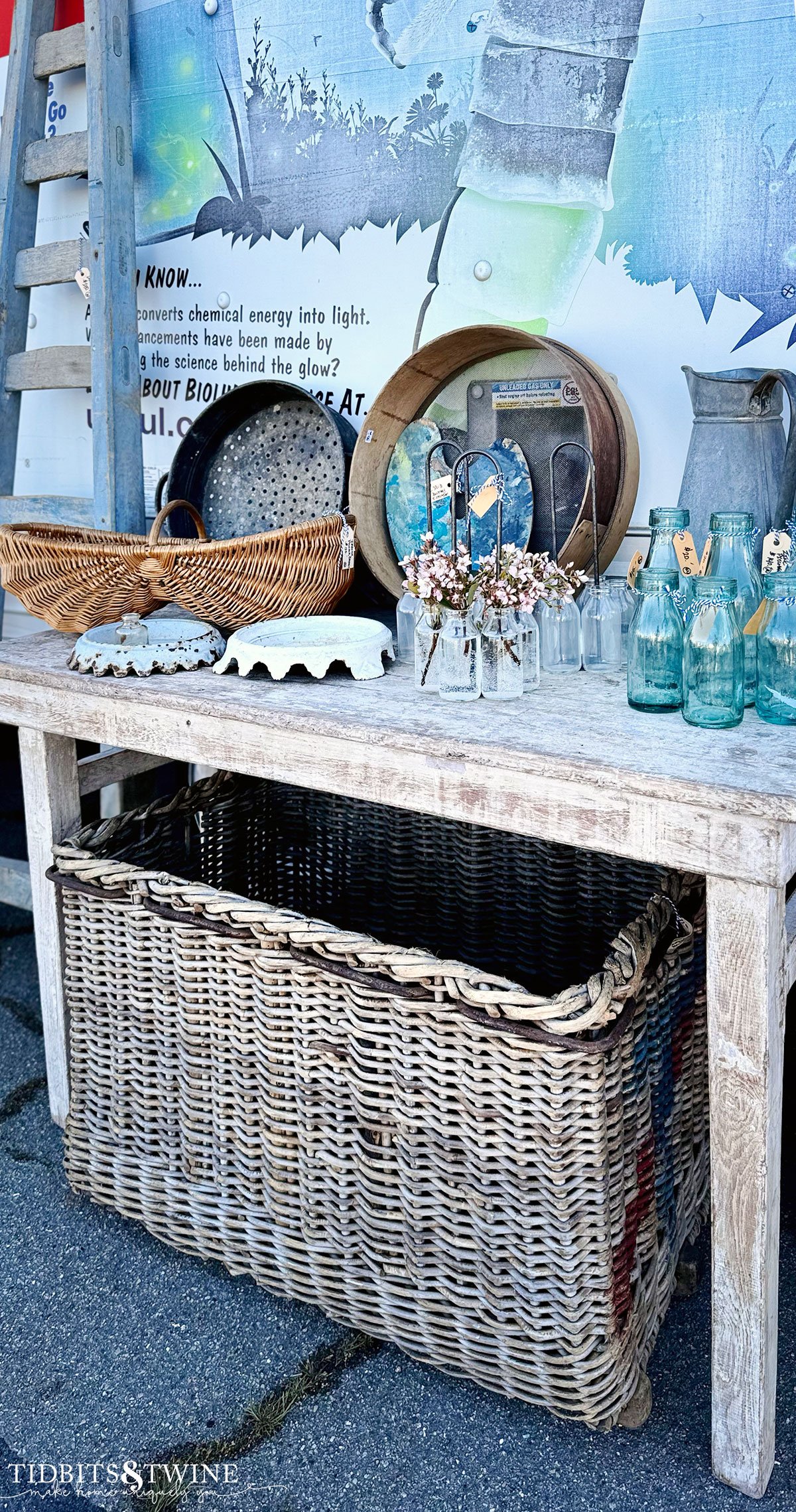 antique fair display with console table with bottles and baskets on top