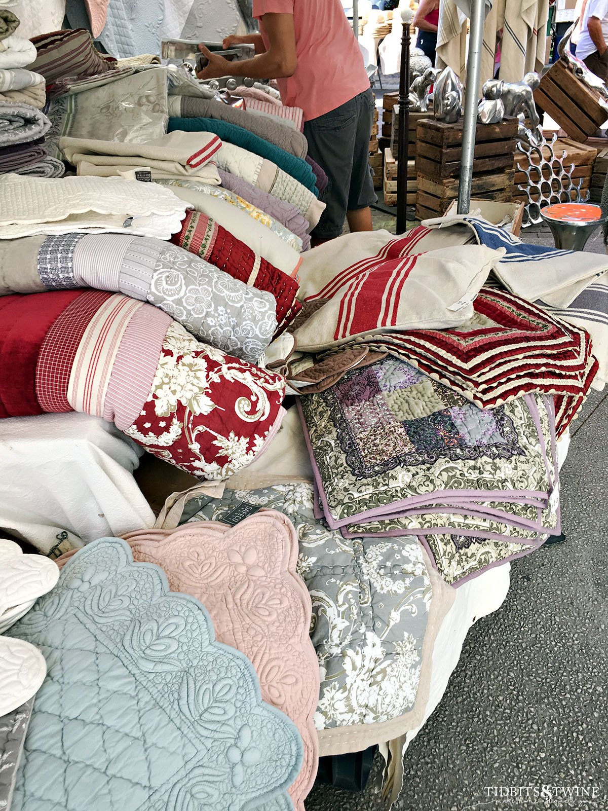 antique french quilts at an outdoor market in france