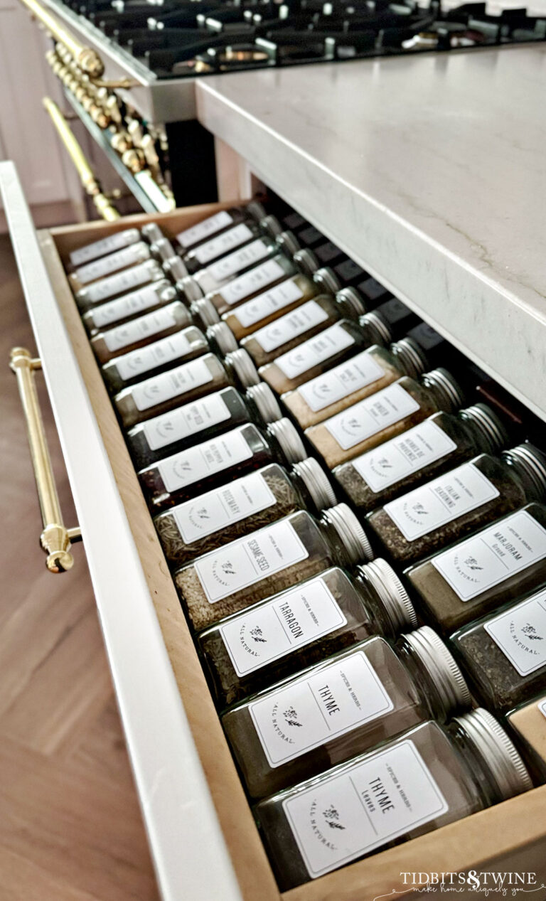 drawer with spice jars and matching labels in white kitchen black ILVE range
