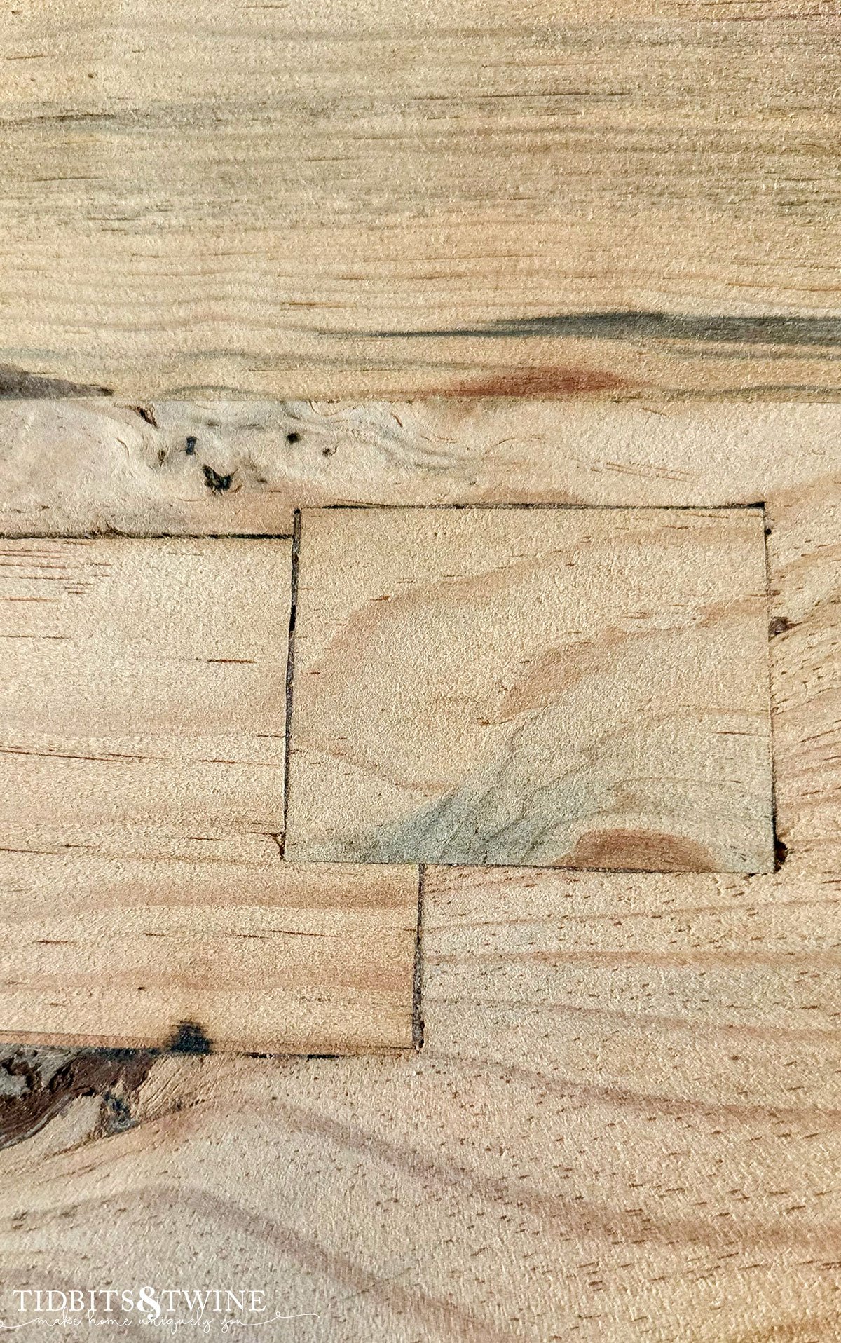 closeup of sanded tabletop showing square patches in the table