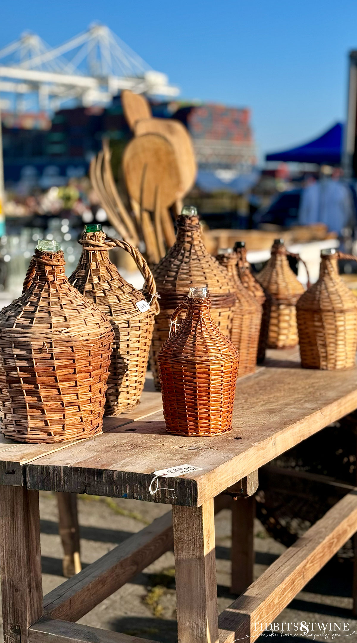 antique wicker demijohns on a wooden table