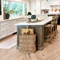 warm white kitchen with quartzite countertops and herringbone floor