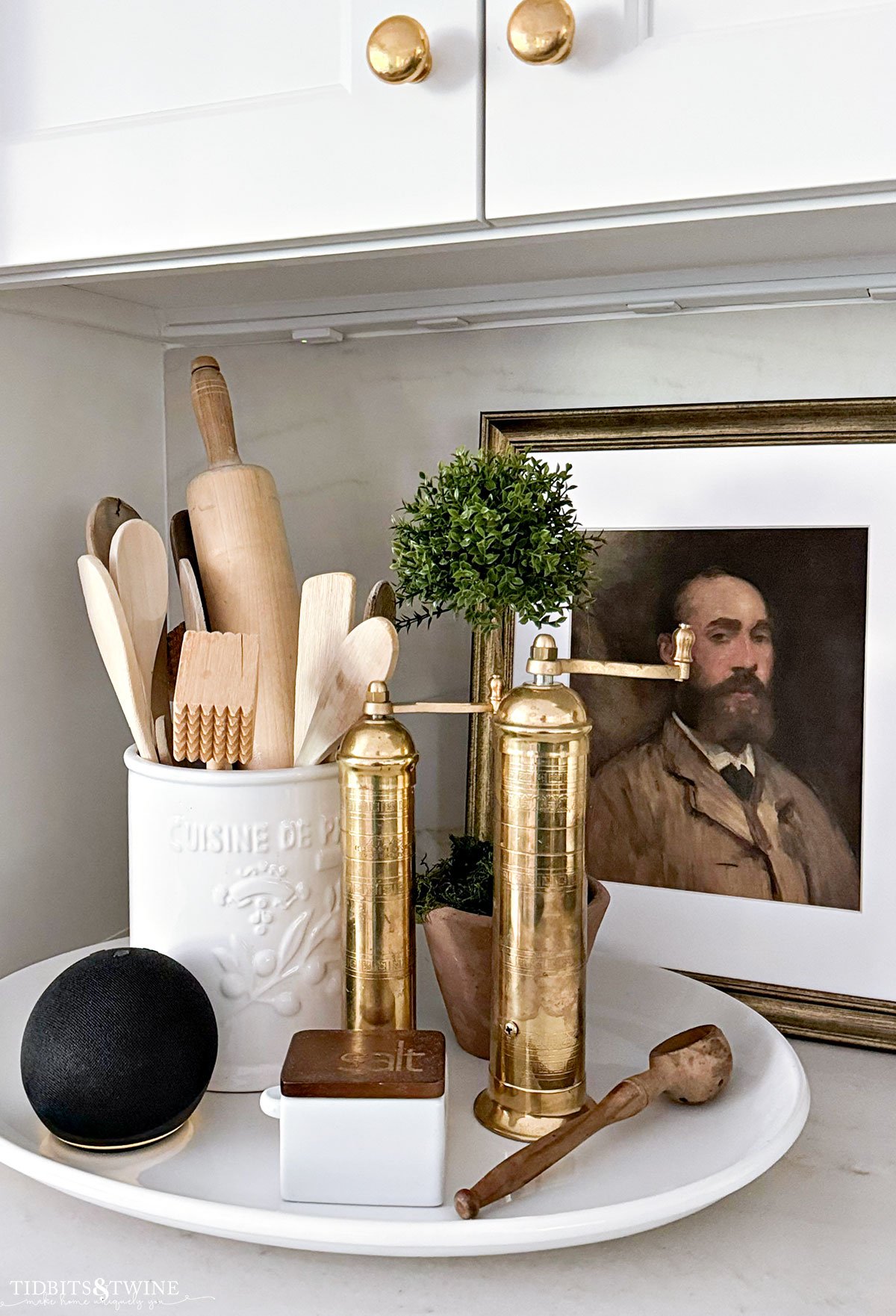 kitchen vignette with brass pepper mill wooden utensils and amazon echo