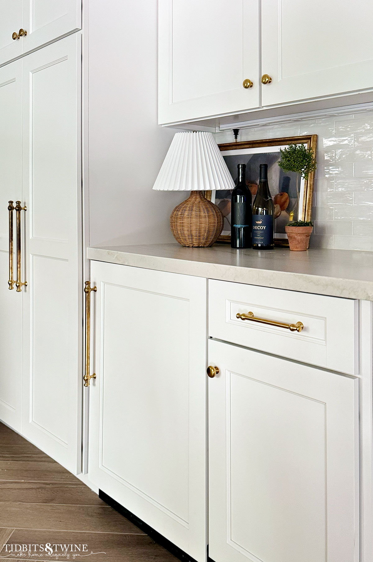 white kitchen corner with paneled beverage fridge and lamp on top of counter