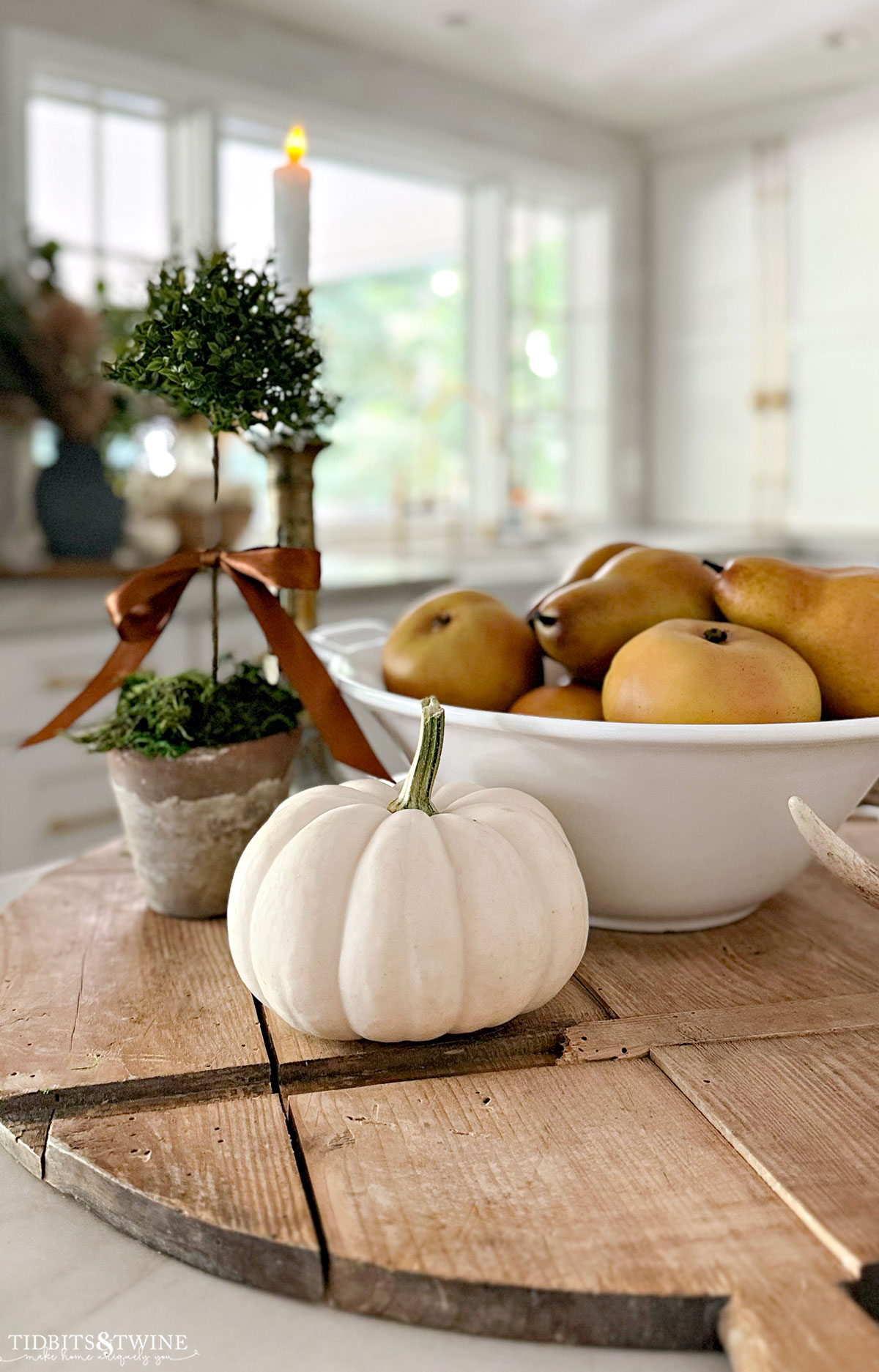 Fall kitchen vignette with bowl of yellow pears white pumpkin and small green topiary - How to Decorate a Kitchen for Fall