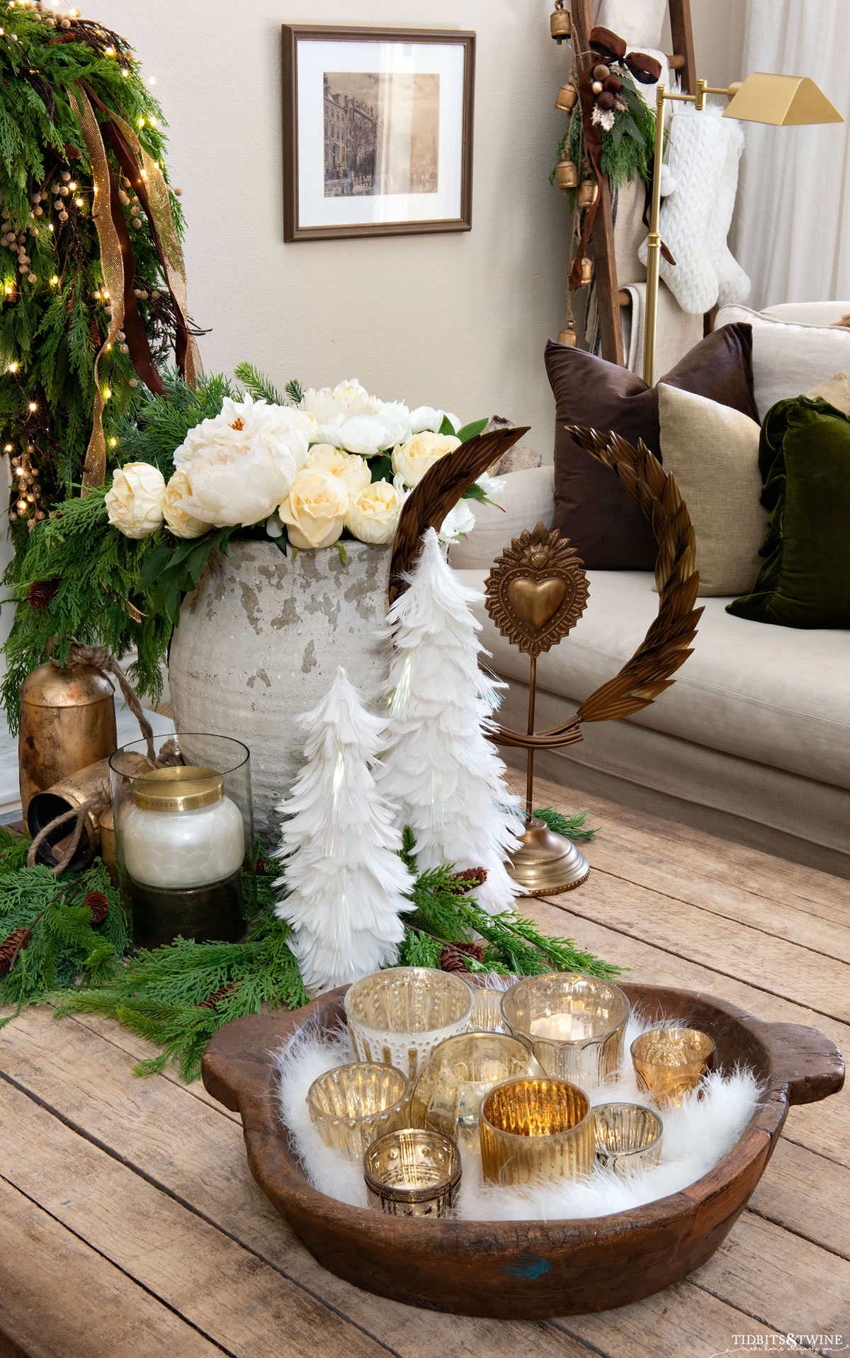 french inspired christmas coffee table decor with votive feather trees and white flowers
