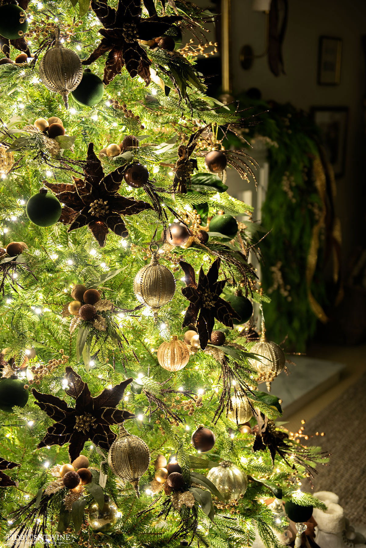 french inspired christmas tree in brown and gold glowing at night