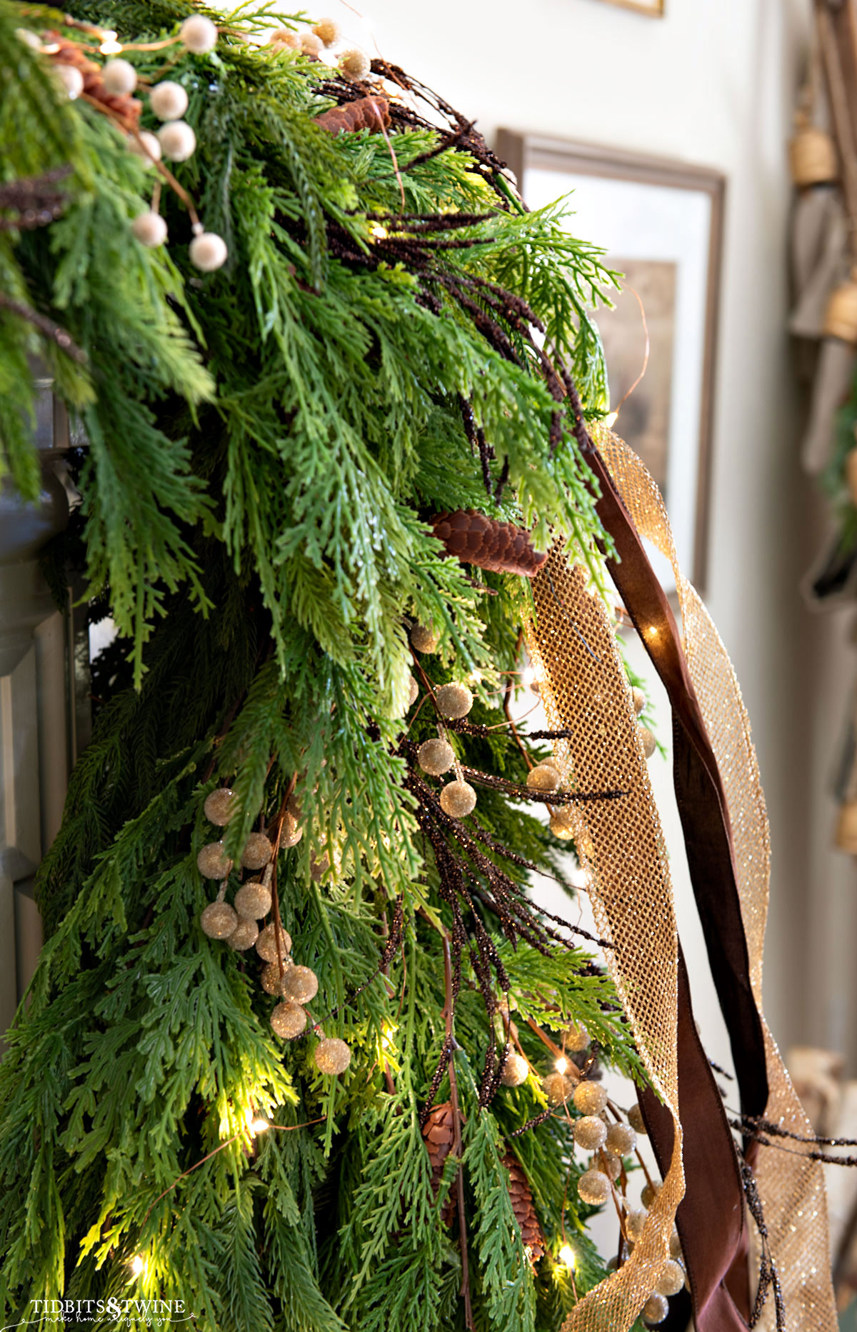closeup of holiday garland on a mantel with brown and gold berries and ribbon