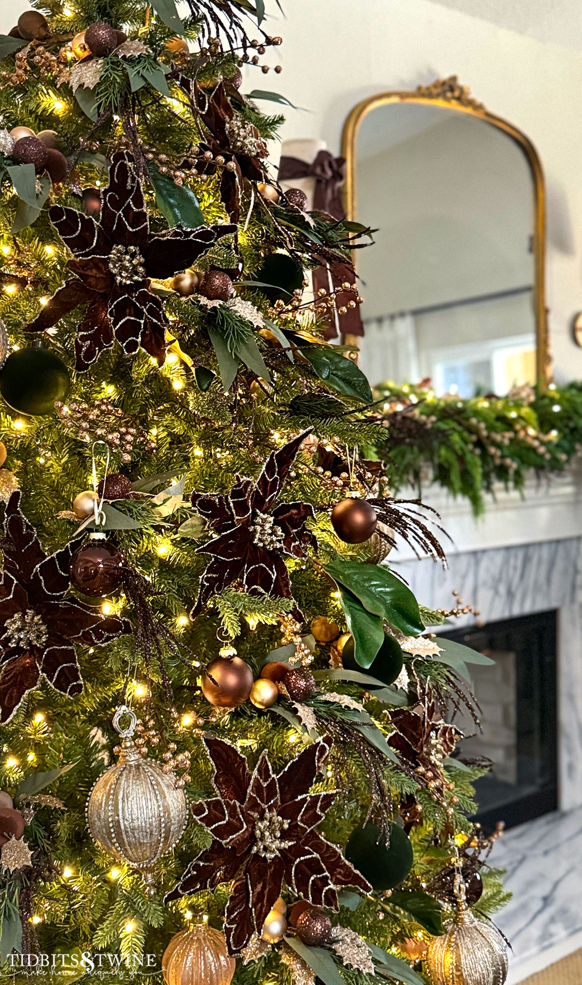 closeup of french inspired  christmas tree with brown flowers bronze ornament and gold accents in a christmas living room