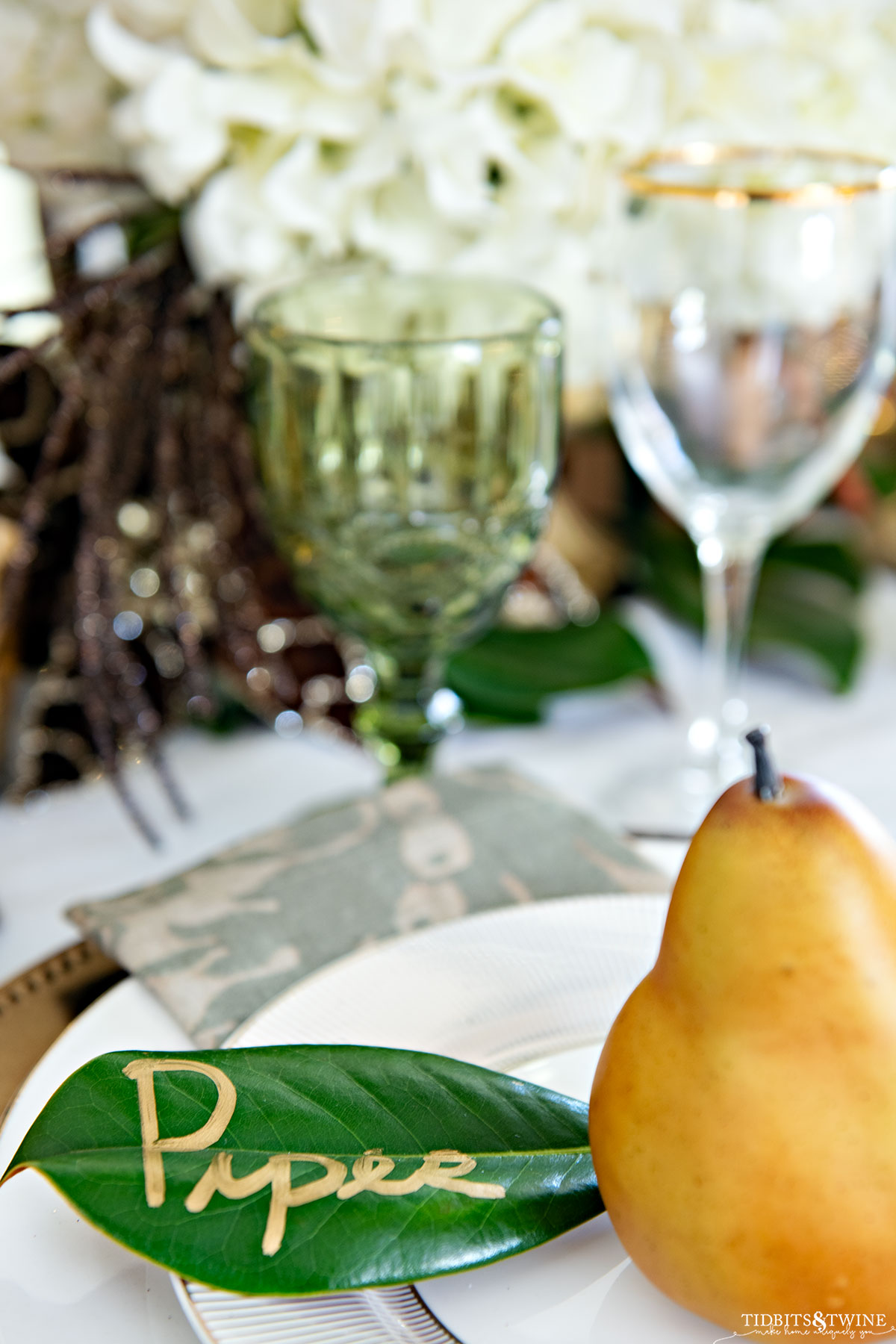 Christmas name cards using magnolia leaf and a pear on each plate