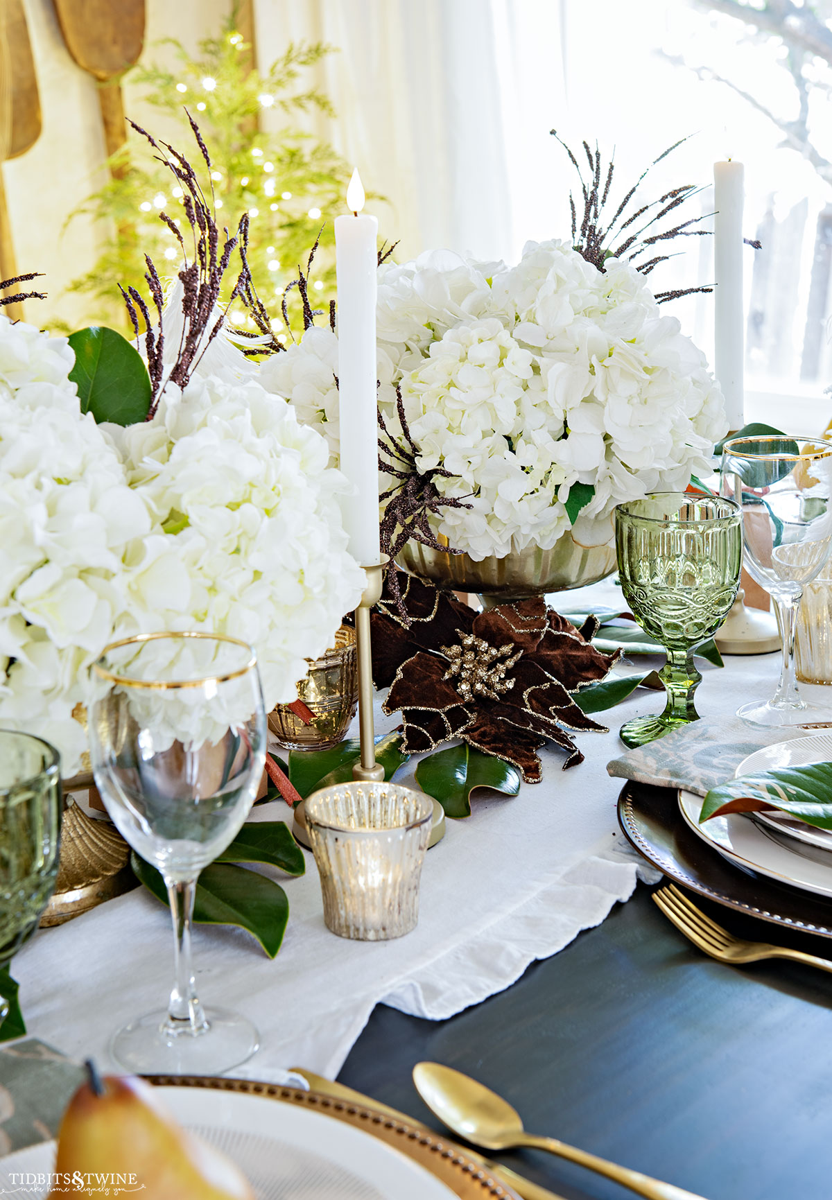 Christmas centerpiece with gold compotes and white hydrangea and brown flowers