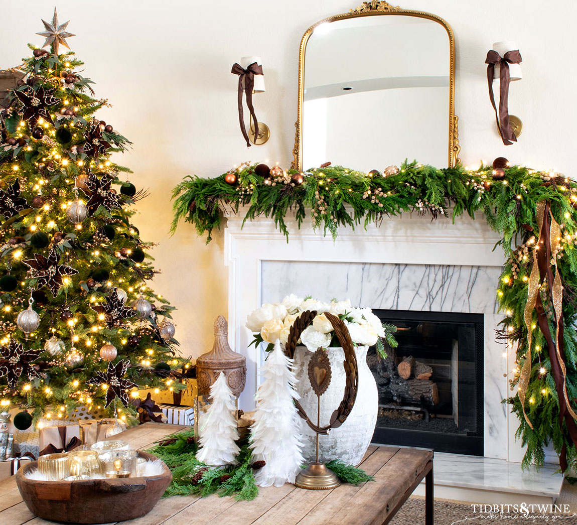 french inspired christmas living room in brown and gold with garland on fireplace