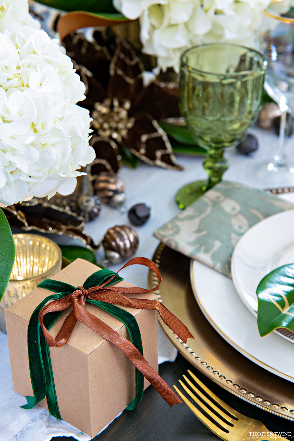 Christmas place setting with small gift box wrapped in ribbon