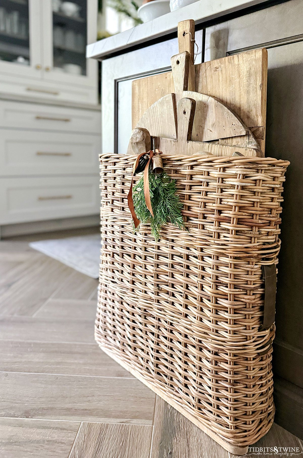 wwii ammo basket holding antique bread boards at end of kitchen island - Bread Board Display Idea