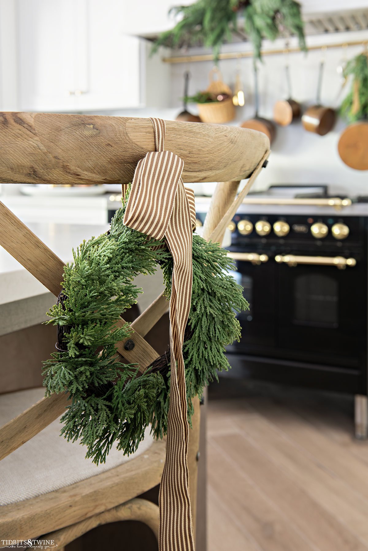 crossback counter stool in kitchen with small holiday wreath hanging on back