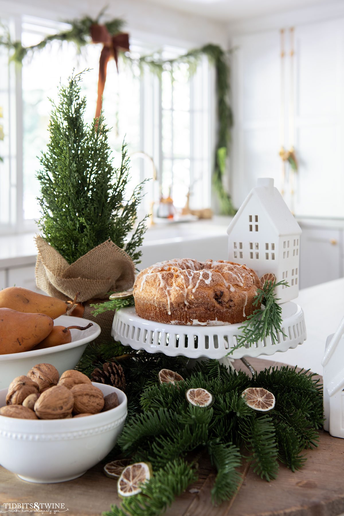 Christmas kitchen display on counter with white bowls greenery and food