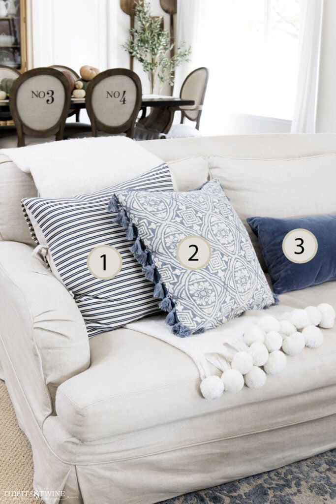 Sofa with five pillows arranged using the rule of odds interior design—two on the left, one centered, two on the right