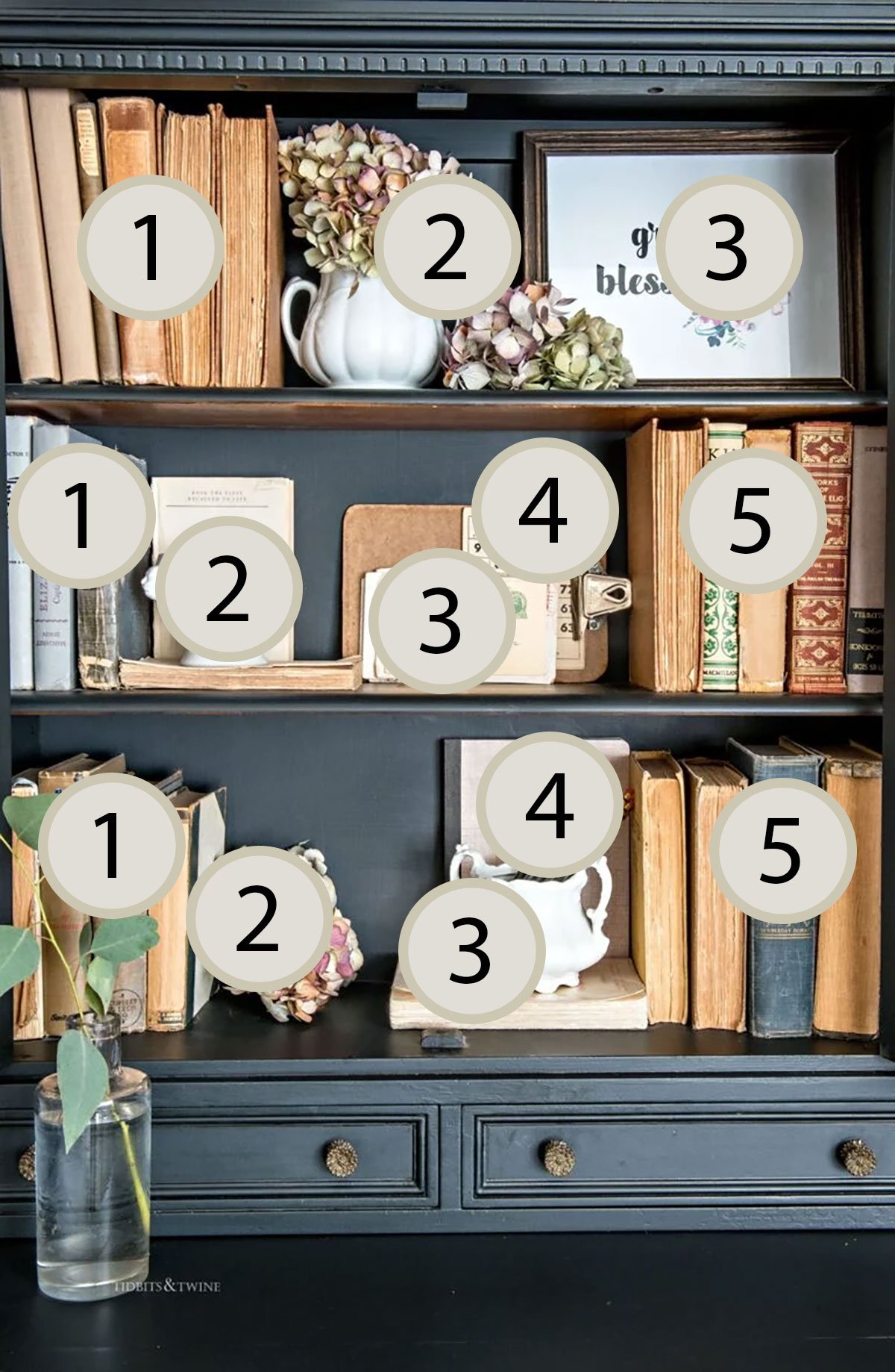 Black hutch styled with books and decor in odd-numbered groupings following the rule of odds interior design