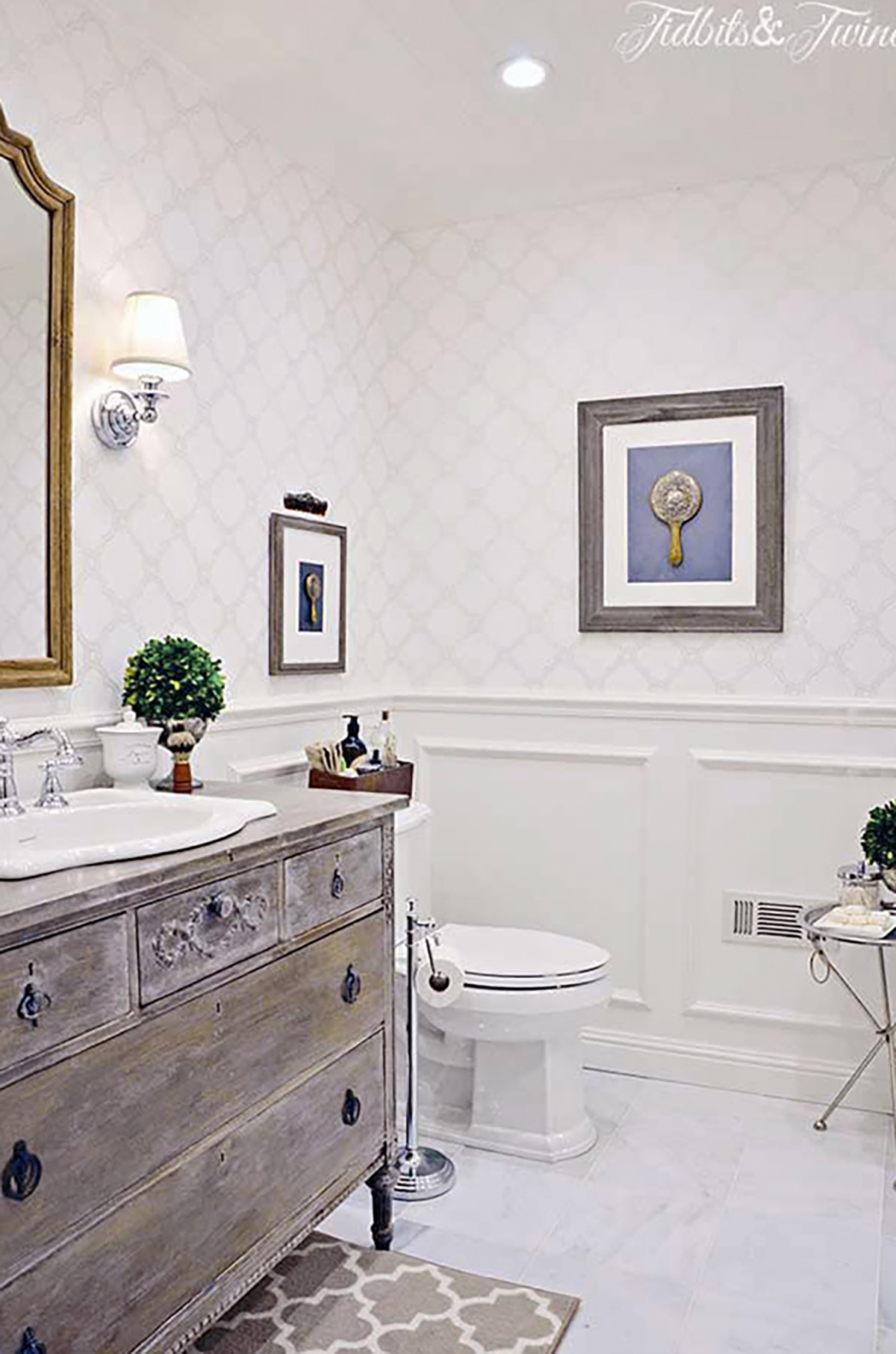 Small bathroom with antique dresser vanity and classic wall molding showing how to make your home look expensive through thoughtful updates.