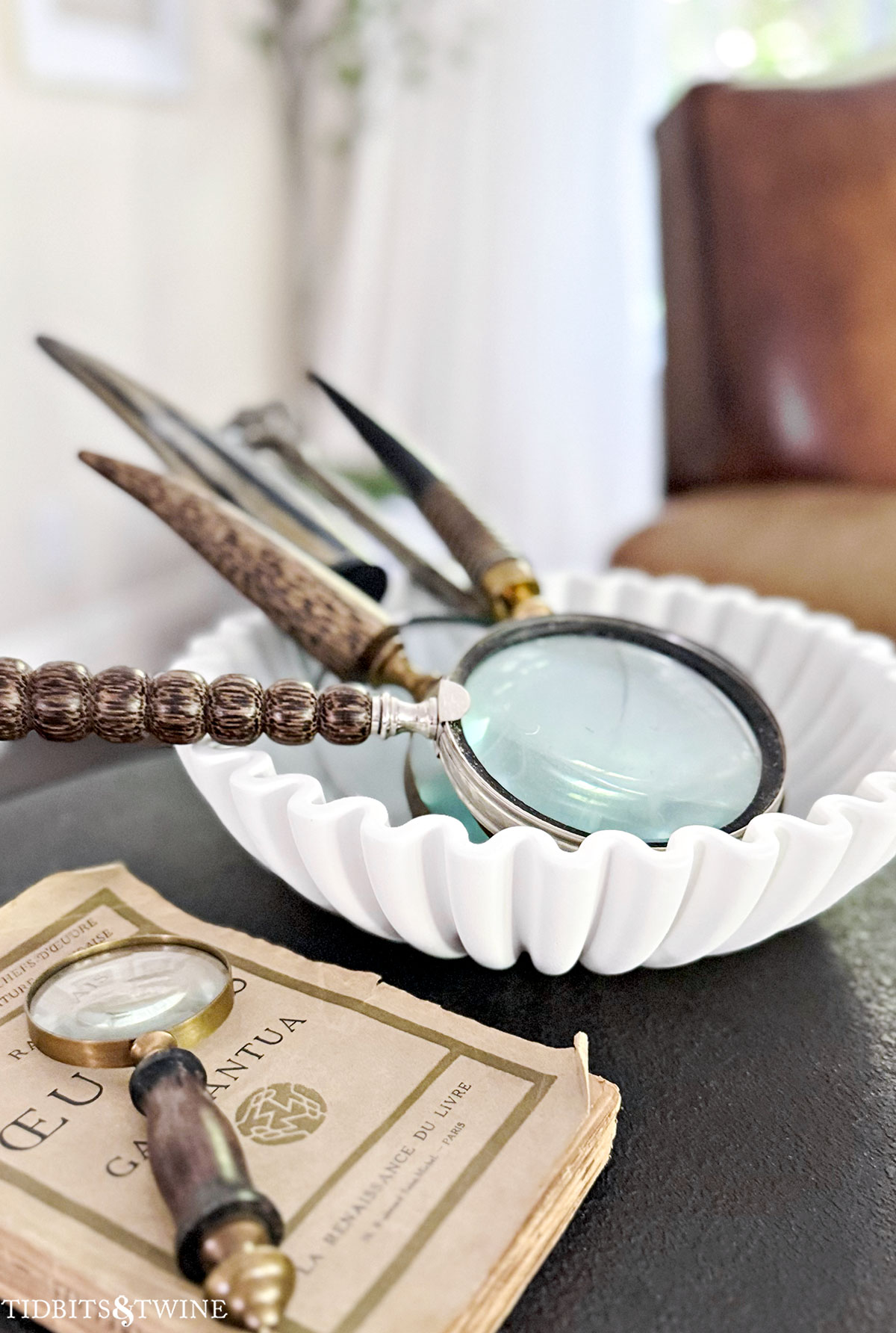 Marble ruffle bowl and magnifying glass on coffee table &mdash; elegant Amazon home decor accent.