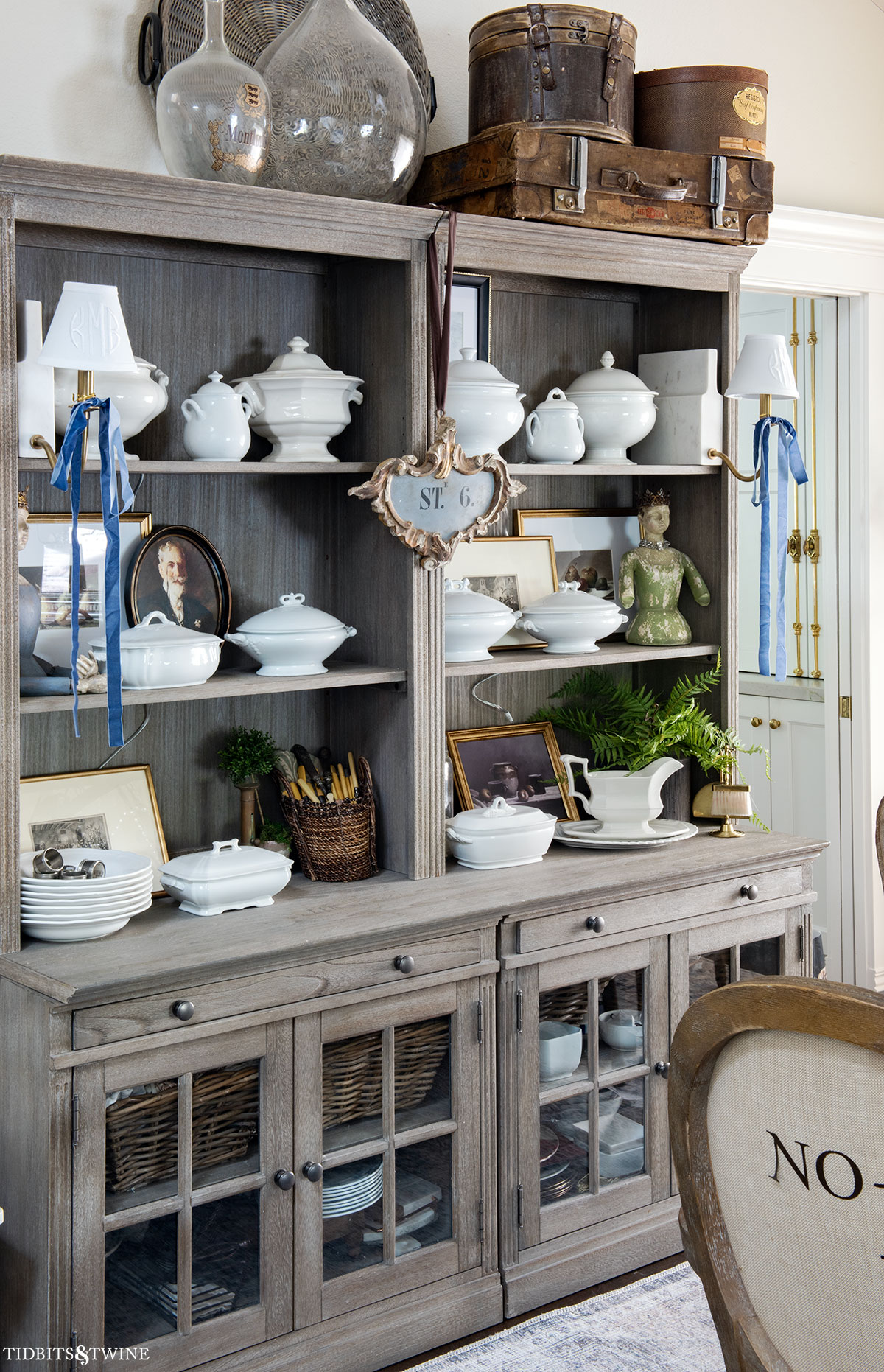 Dining room hutch displaying a curated ironstone collection on open shelves