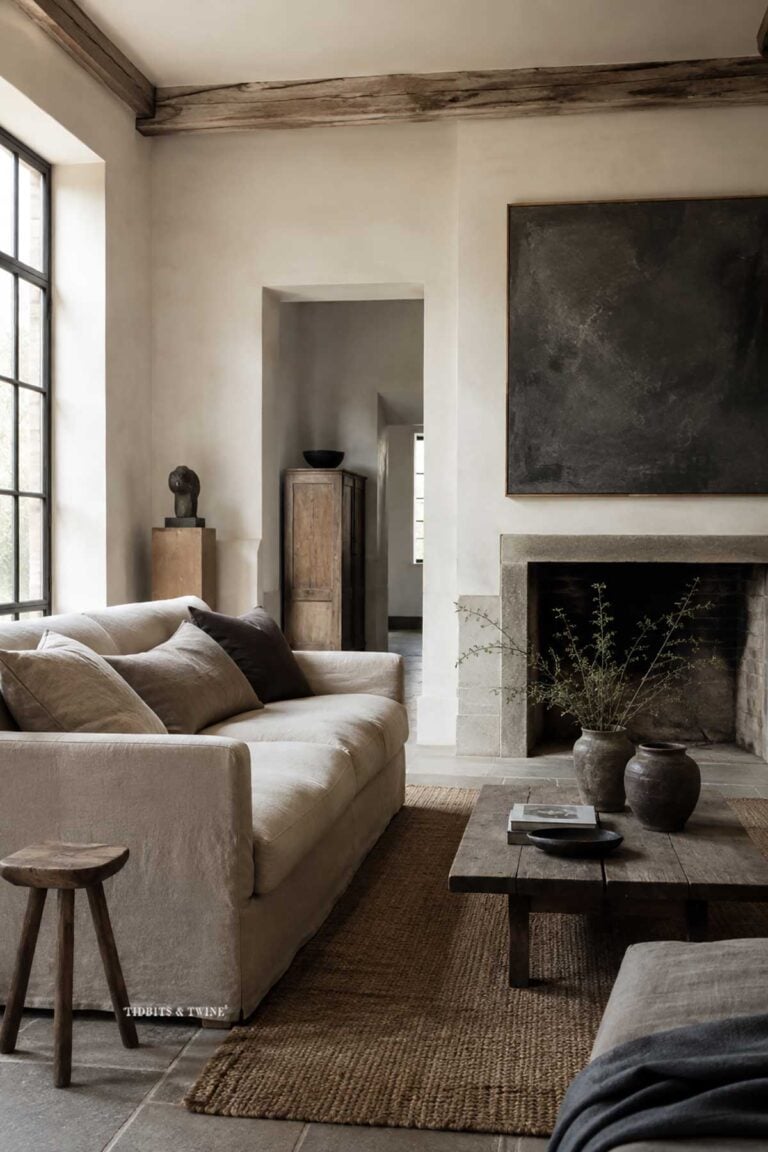 Belgian living room with neutral linen furniture, aged wood, natural textures, and restrained styling