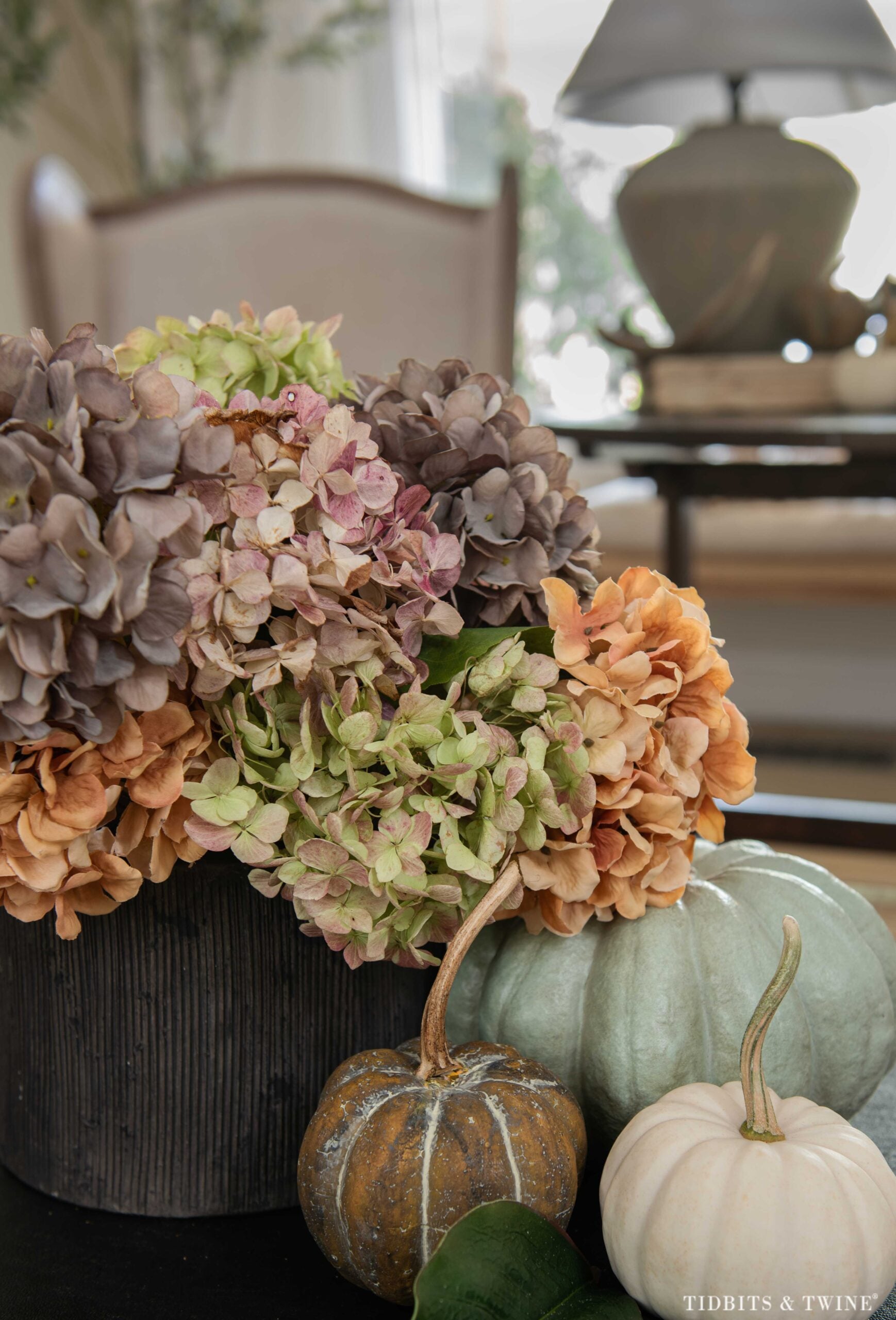 Mixed dried and faux hydrangeas in muted green, plum, pink and orange