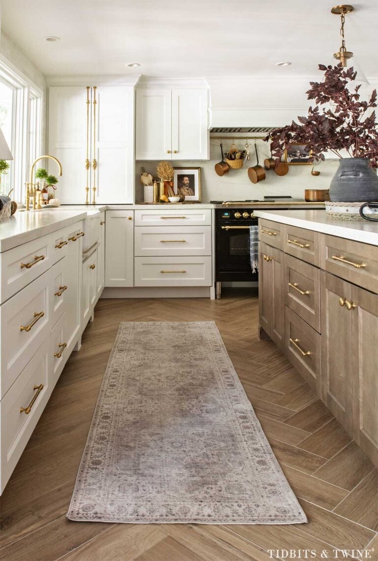 White and wood kitchen decorated with simple fall accents and burgundy branches