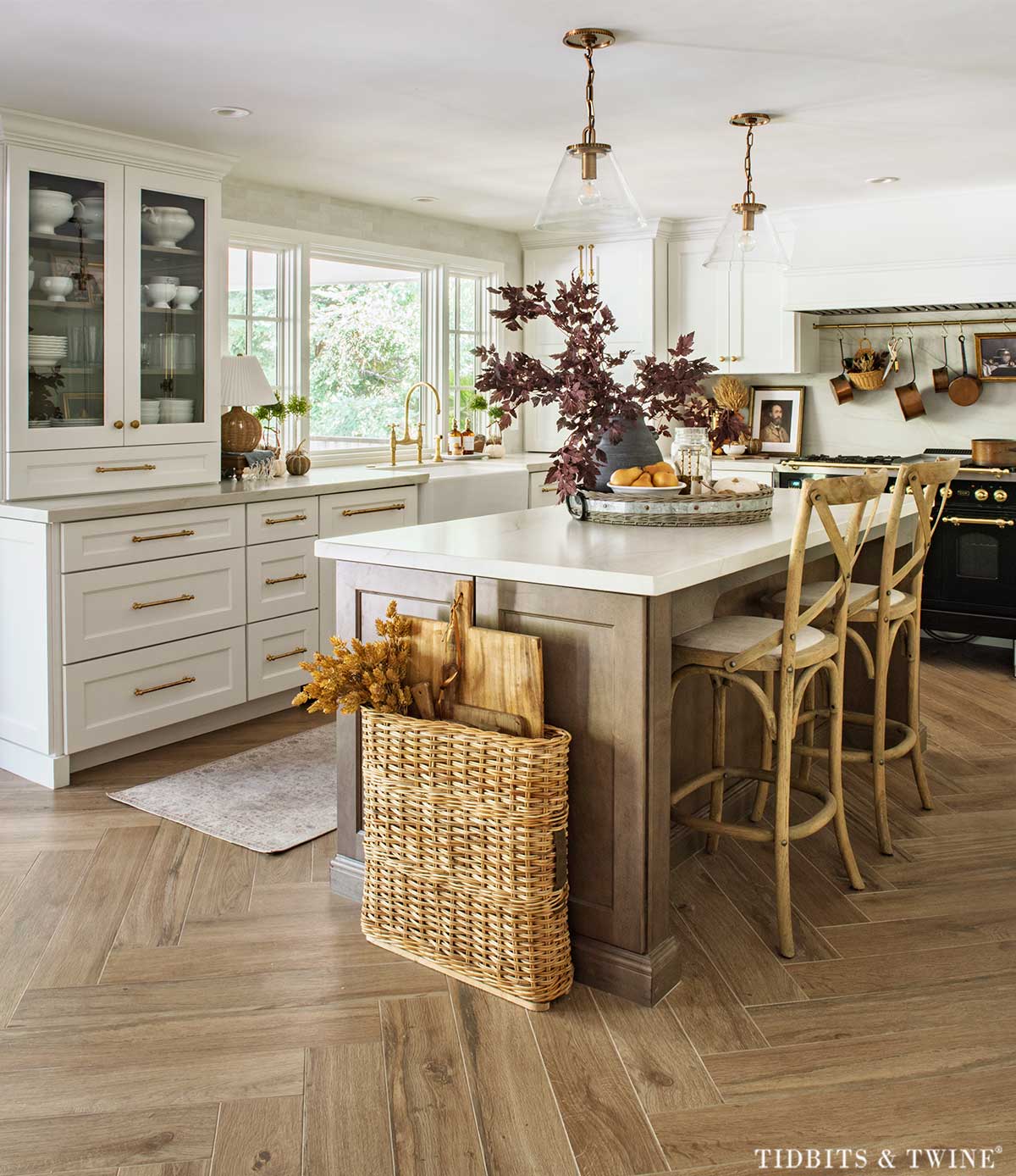 Fall kitchen decor with burgundy branches, faux pears, white pumpkins and vintage breadboards