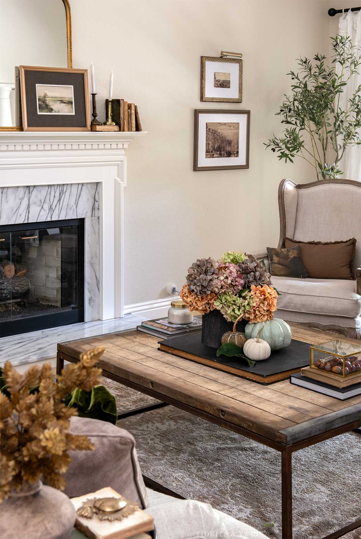 Fall living room decorated with hydrangeas, pumpkins, warm wood and natural elements