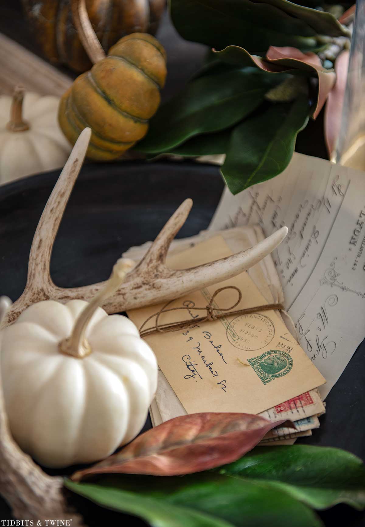 all vignette on a French wine tasting table beside an upholstered chair